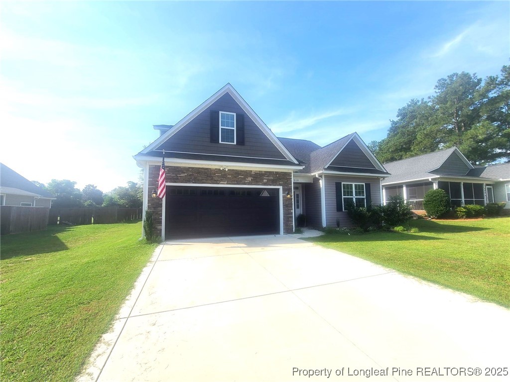 519 Hammond Farms Road Hope Mills, NC 28348 - Photo 3 of 34 a front view of a house with garden