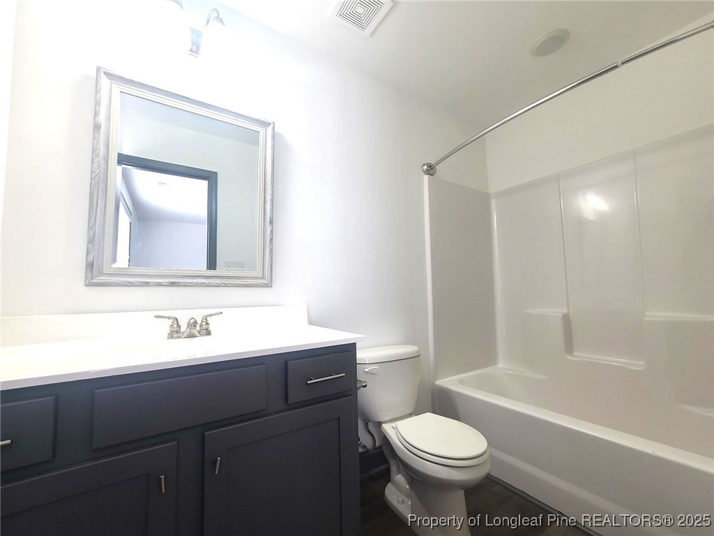 519 Hammond Farms Road Hope Mills, NC 28348 - Photo 33 of 34 a bathroom with a toilet sink and mirror