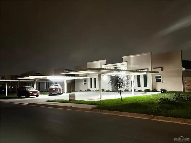 a view of house with yard in front of it