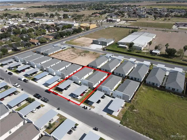 an aerial view of residential houses with outdoor space