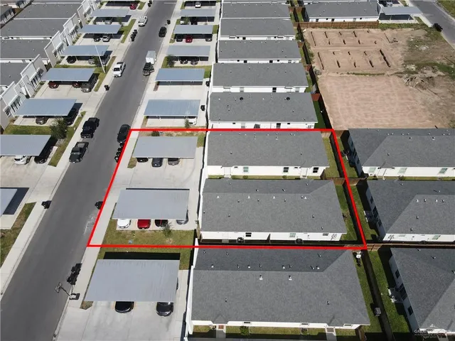 an aerial view of residential houses with street