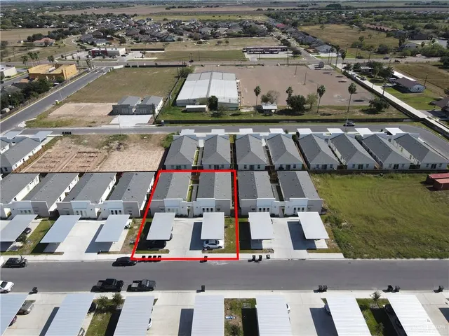 an aerial view of residential houses with outdoor space