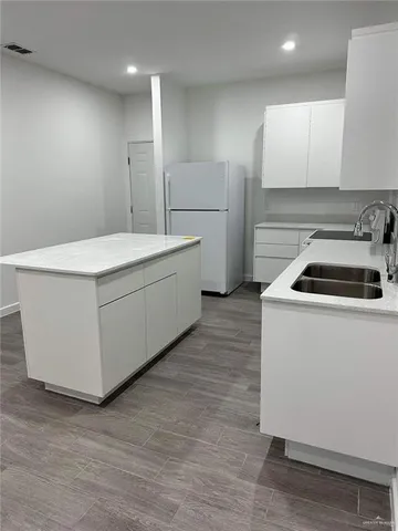 a kitchen that has a sink and a stove in it