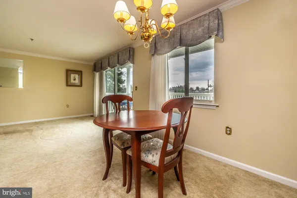 a dining room with furniture and chandelier
