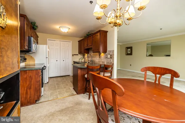 a kitchen with stainless steel appliances granite countertop a sink dishwasher stove and cabinets
