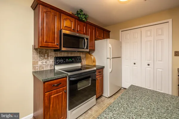 a kitchen with stainless steel appliances a refrigerator stove and microwave