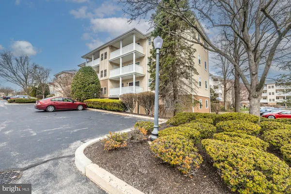 a view of a room that has a window and furniture