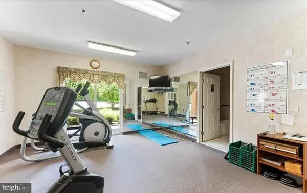 a living room with furniture a chandelier and a fireplace