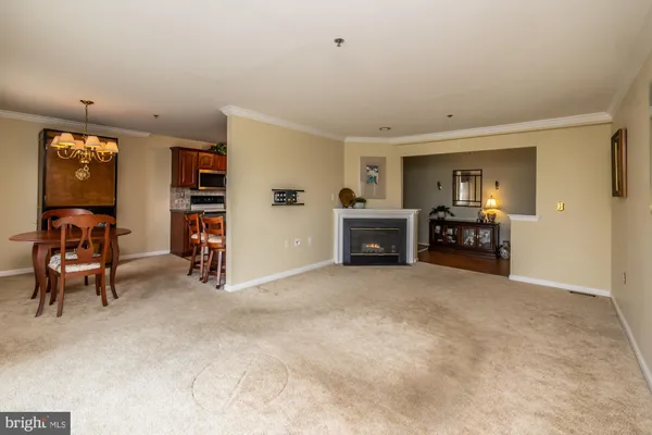 a view of a livingroom with an empty space and a fireplace
