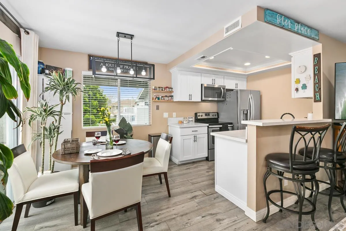 750 Timber Cove Way Oceanside, CA 92058 - Photo 11 of 26 a kitchen with kitchen island a dining table and chairs