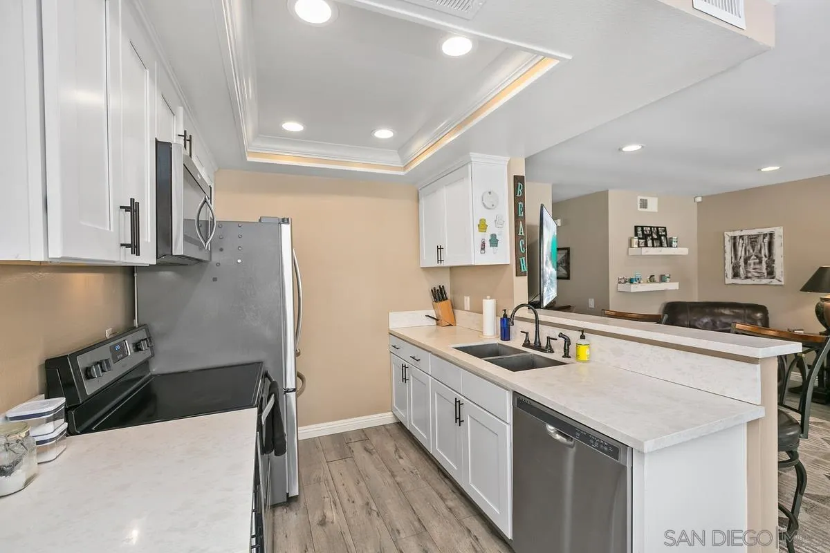 750 Timber Cove Way Oceanside, CA 92058 - Photo 13 of 26 a kitchen with stainless steel appliances a sink stove and refrigerator