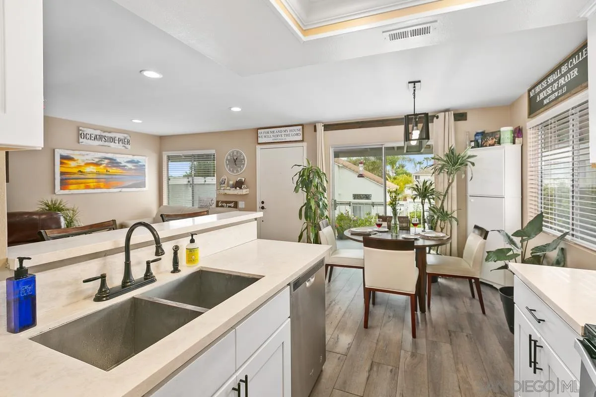 750 Timber Cove Way Oceanside, CA 92058 - Photo 14 of 26 a kitchen with a sink a counter and chairs