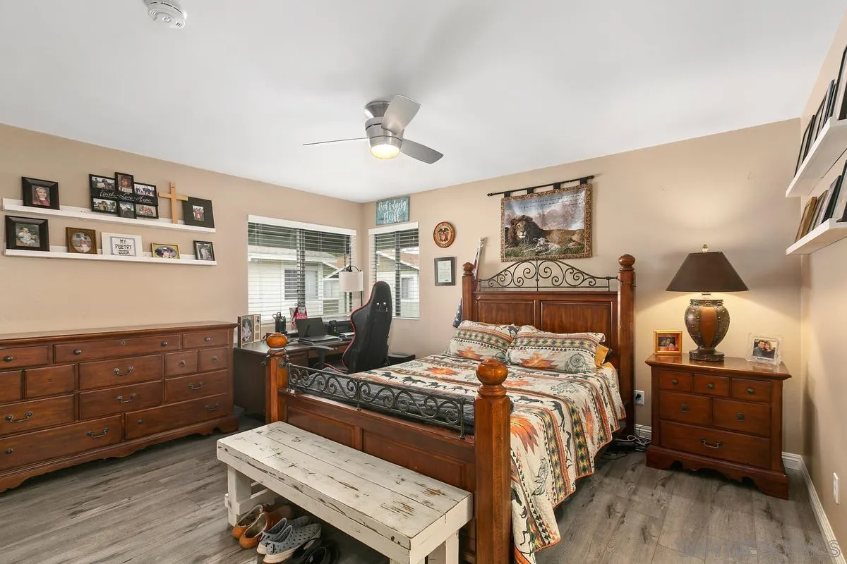 750 Timber Cove Way Oceanside, CA 92058 - Photo 15 of 26 a bedroom with a bed and wooden floor