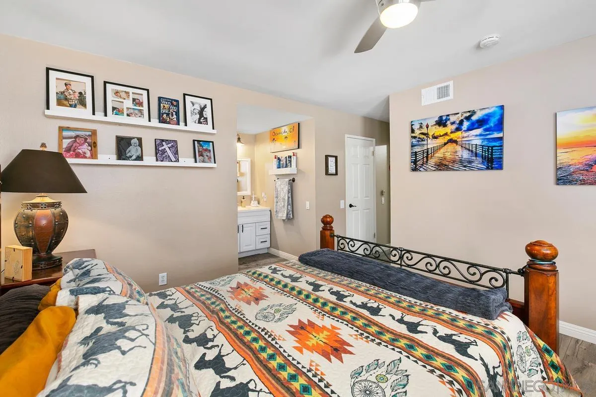 750 Timber Cove Way Oceanside, CA 92058 - Photo 17 of 26 a bedroom with bed and painting on the wall