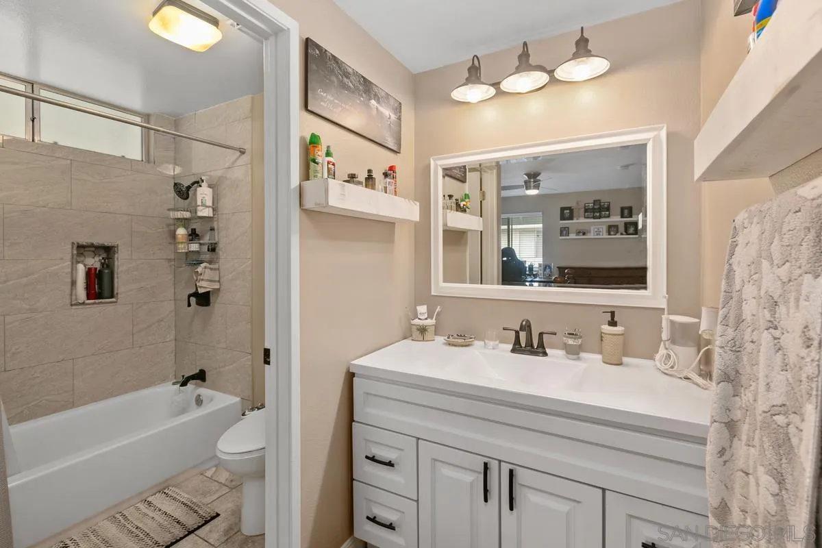 750 Timber Cove Way Oceanside, CA 92058 - Photo 18 of 26 a bathroom with a sink vanity granite tub and shower