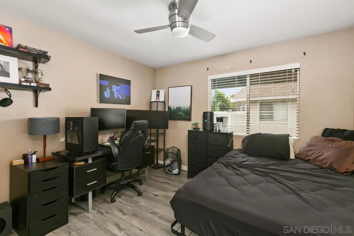 750 Timber Cove Way Oceanside, CA 92058 - Photo 20 of 26 a bedroom with a bed and wooden floor