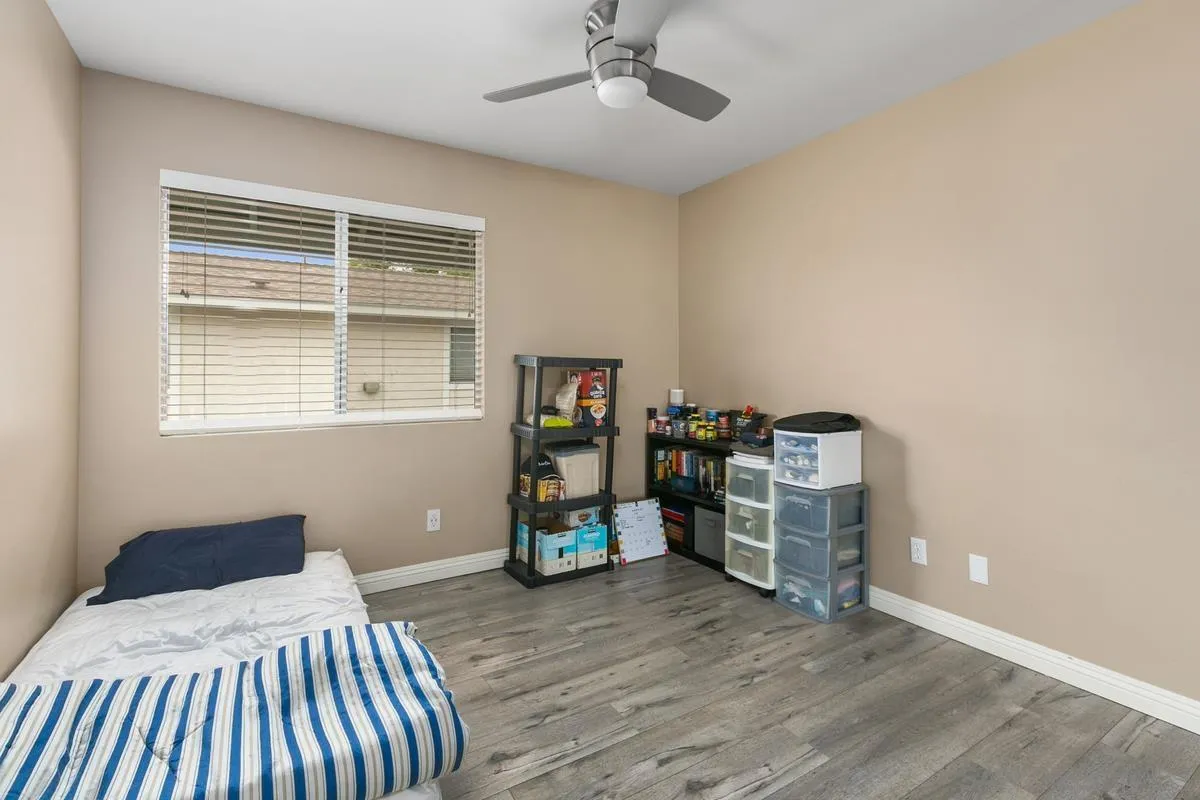 750 Timber Cove Way Oceanside, CA 92058 - Photo 21 of 26 a bedroom with a bed and a chandelier