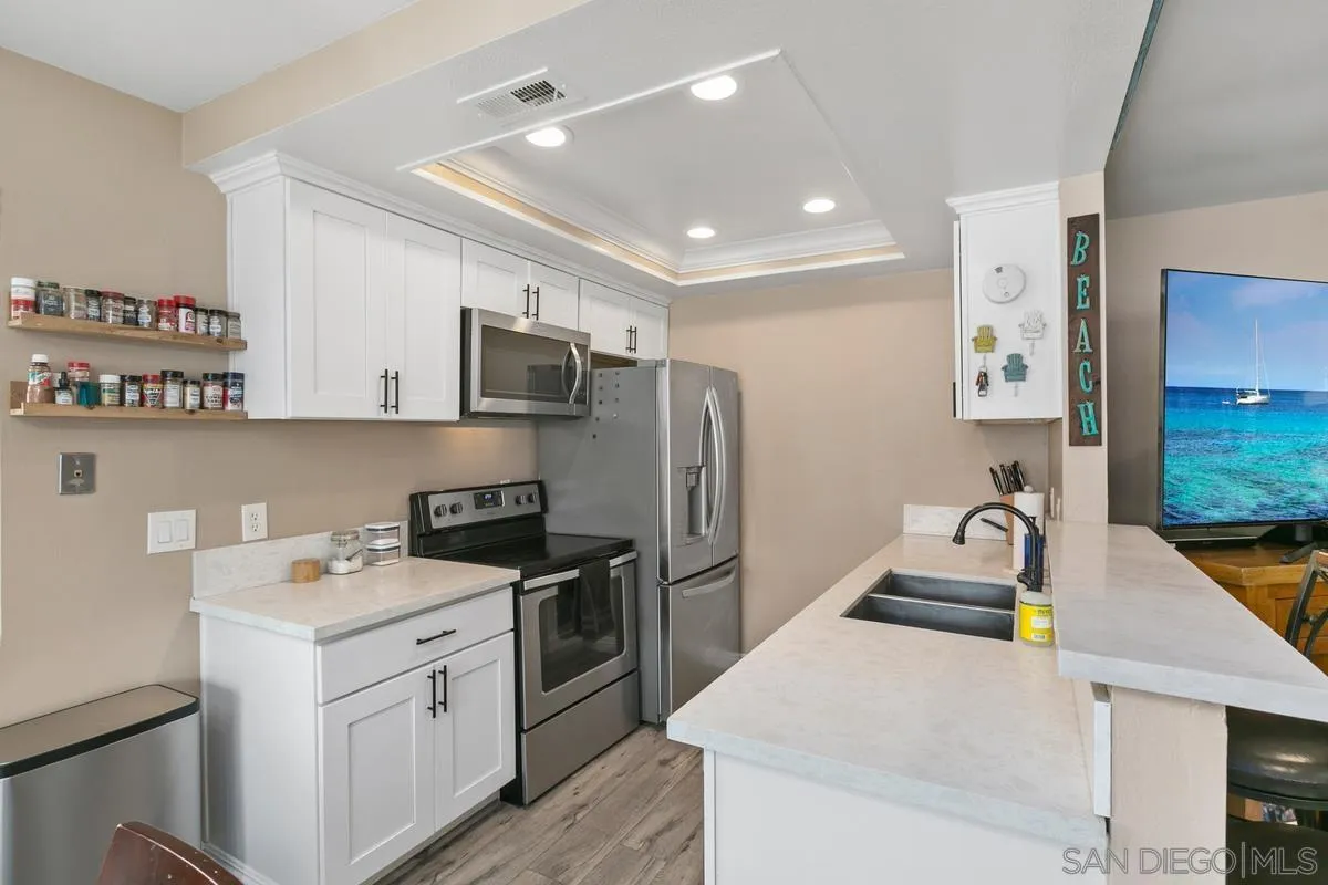 750 Timber Cove Way Oceanside, CA 92058 - Photo 4 of 26 a kitchen that has a sink and a stove in it