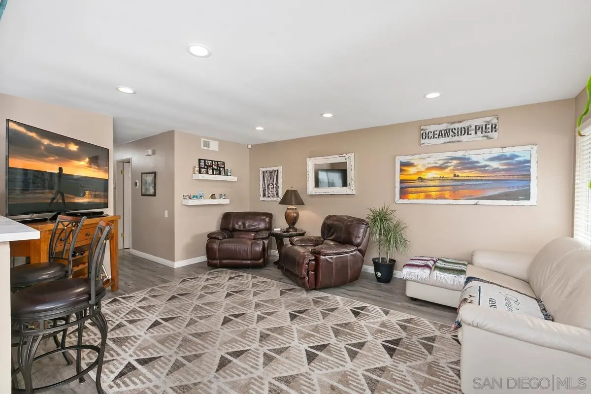 750 Timber Cove Way Oceanside, CA 92058 - Photo 9 of 26 a living room with furniture a flat screen tv and a window