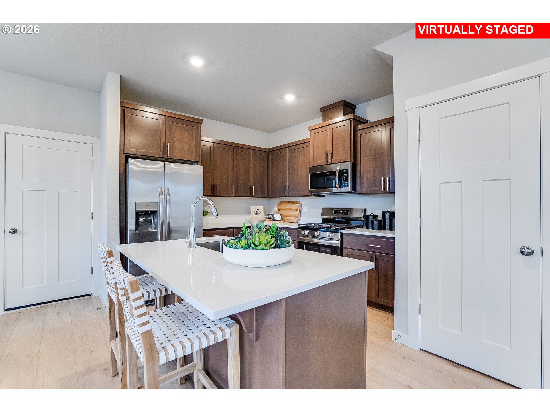 16648 Southwest Darling Lane Tigard, OR 97224 - Photo 5 of 22 a kitchen with kitchen island a refrigerator stove microwave and cabinets