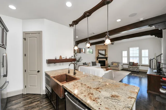 a kitchen with a stove a refrigerator and cabinets