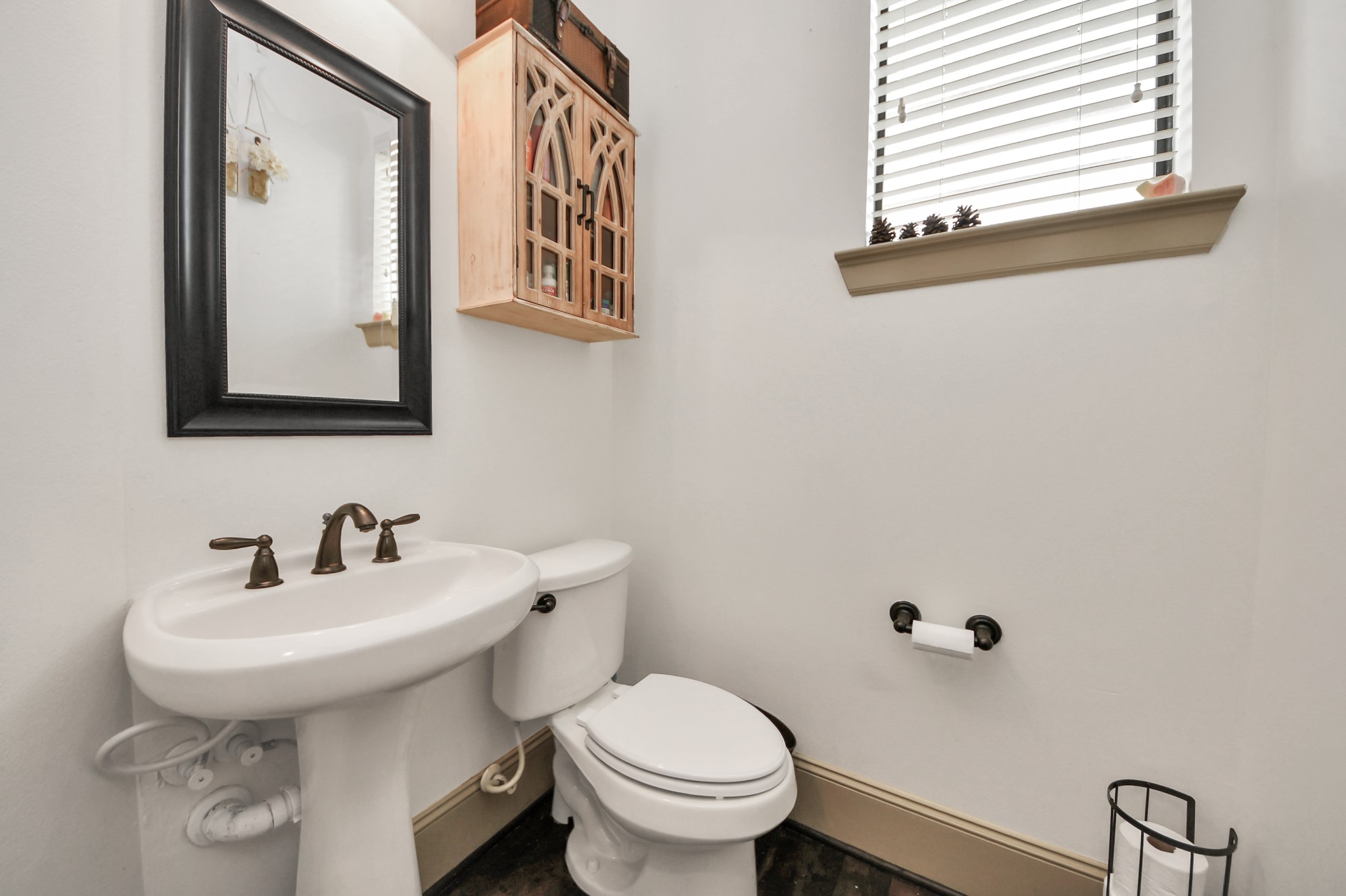 1141 West 23rd Street, Unit A Houston, TX 77008 - Photo 21 of 35 a bathroom with a toilet sink and mirror