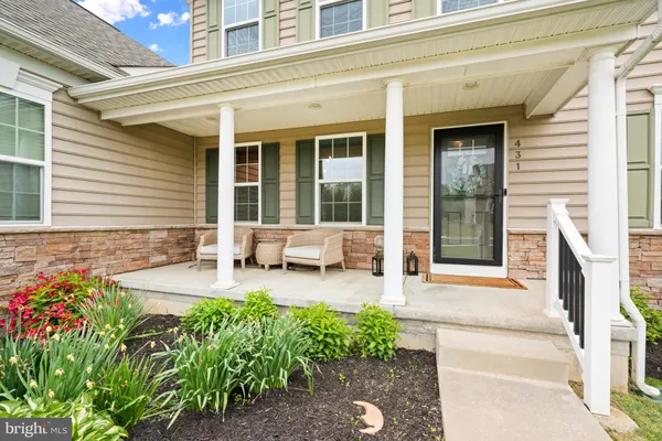 a front view of a house with patio and wooden fence