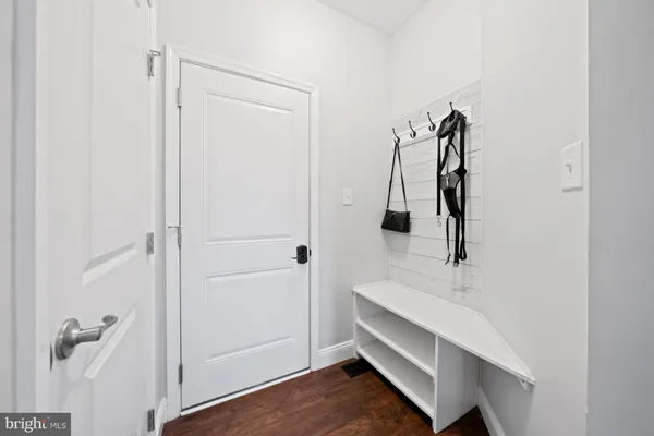 a spacious bedroom with a bed a dresser and windows