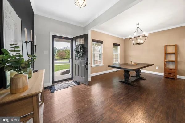 a dining room with table chairs and wooden floor