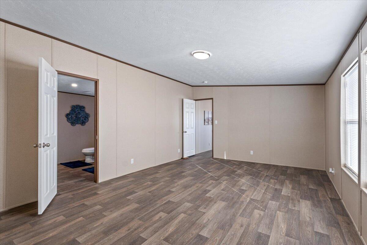 516 Sage Road Tahoka, TX 79373 - Photo 11 of 30 wooden floor in an empty room with a window