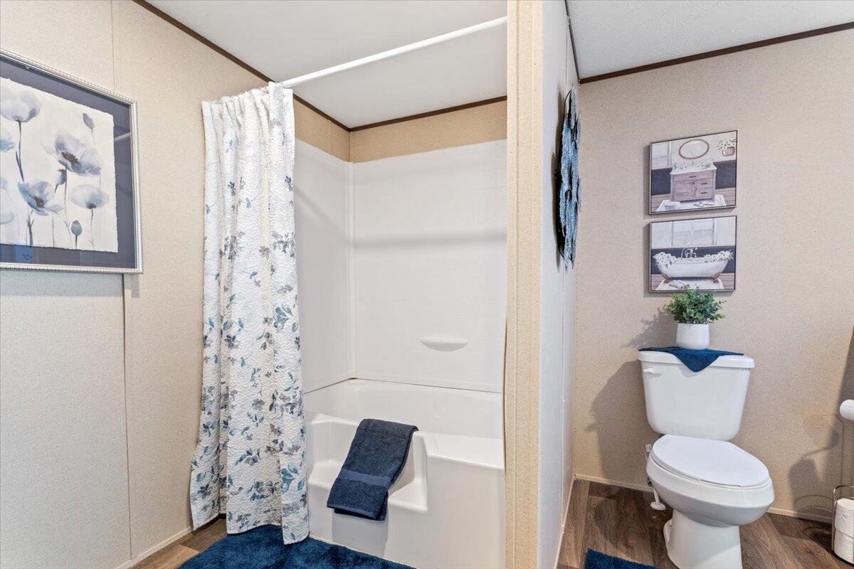 516 Sage Road Tahoka, TX 79373 - Photo 13 of 30 a white toilet sitting next to a bathroom sink