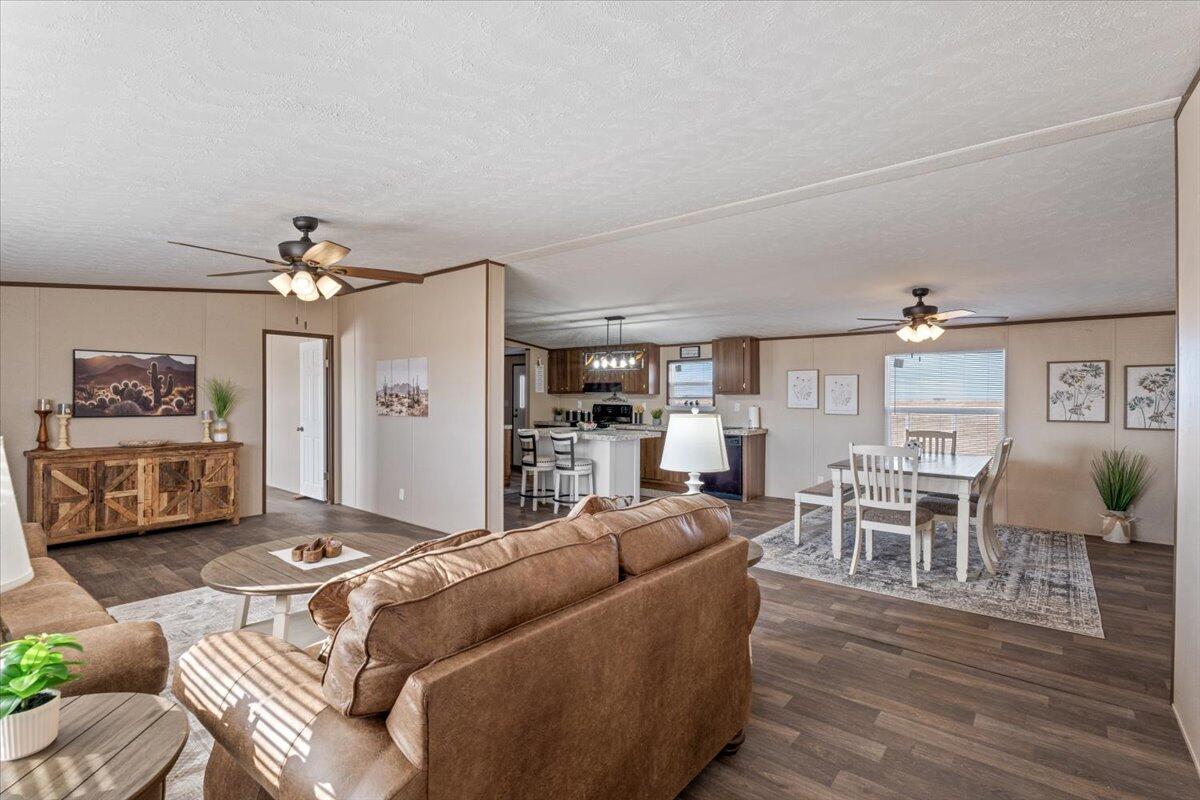 516 Sage Road Tahoka, TX 79373 - Photo 3 of 30 a living room with furniture a chandelier and a wooden floor