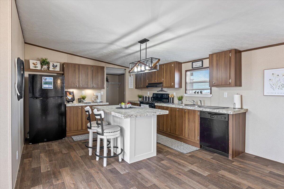 516 Sage Road Tahoka, TX 79373 - Photo 7 of 30 a kitchen with a refrigerator and a stove top oven
