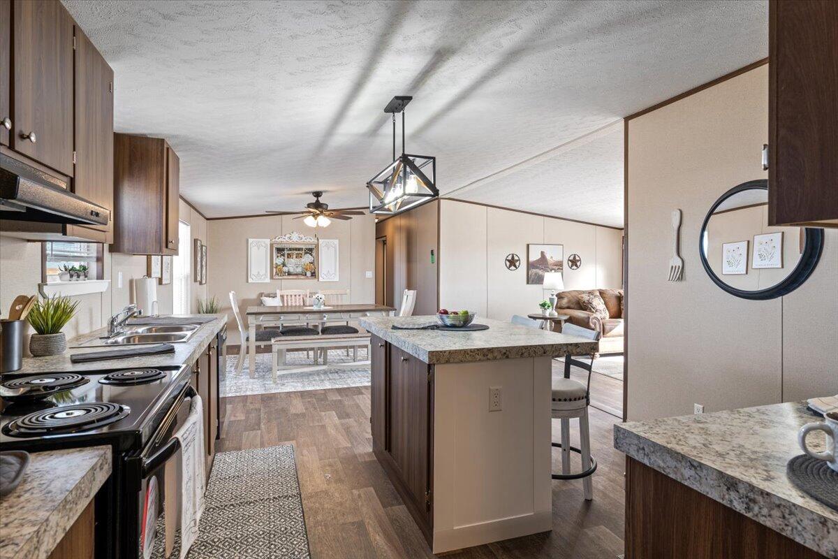 516 Sage Road Tahoka, TX 79373 - Photo 8 of 30 a kitchen with a stove a sink and a refrigerator