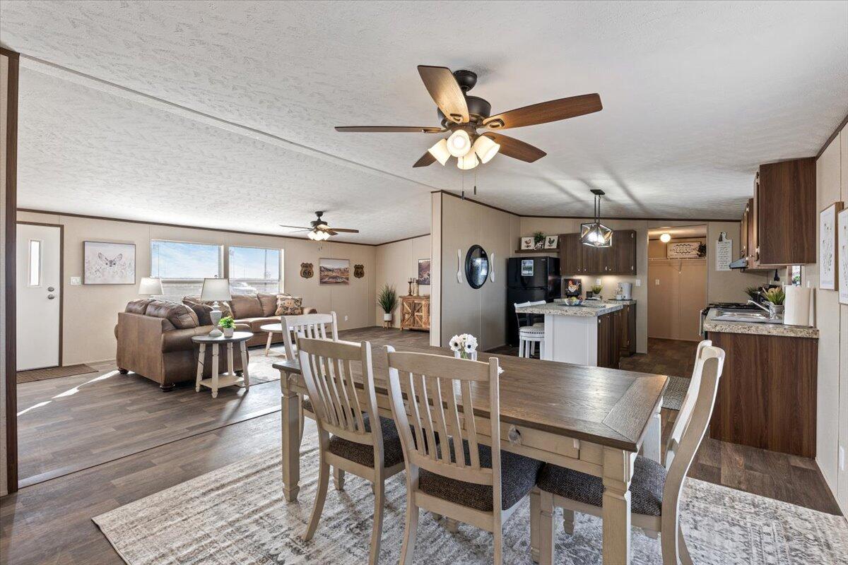 516 Sage Road Tahoka, TX 79373 - Photo 9 of 30 a view of a dining room with furniture and wooden floor
