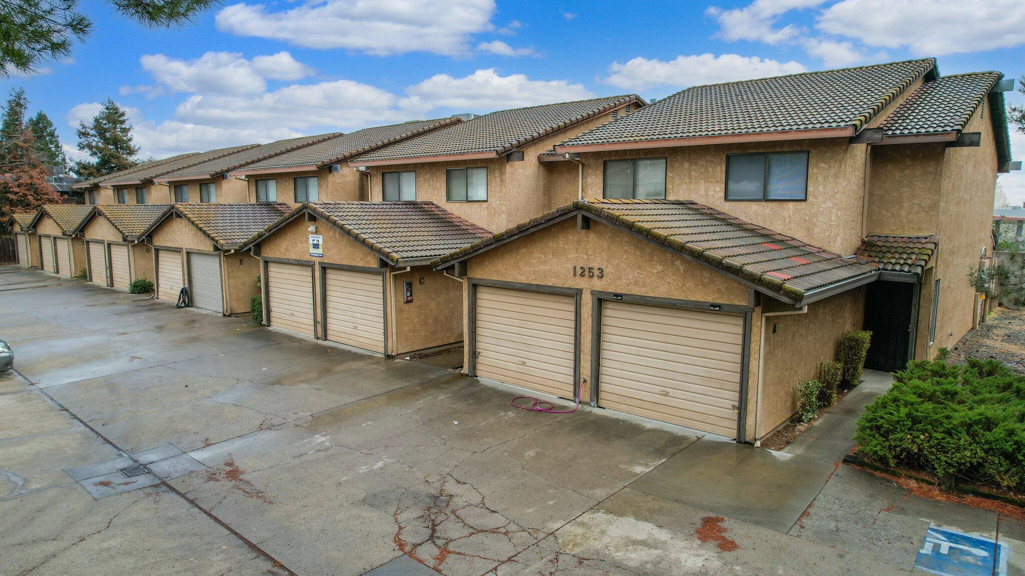 1253 Brandon Court Redding, CA 96003 - Photo 5 of 19 a view of a white house with large windows and a garage