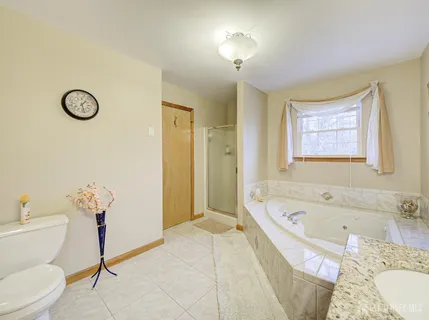 a bathroom with a tub sink and a toilet