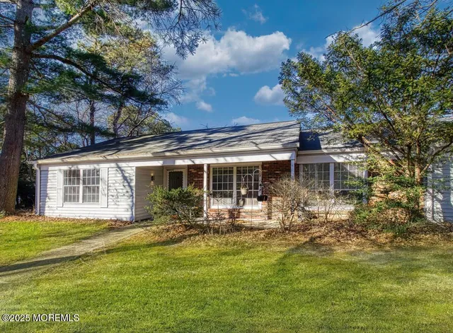 a front view of house with yard and seating area