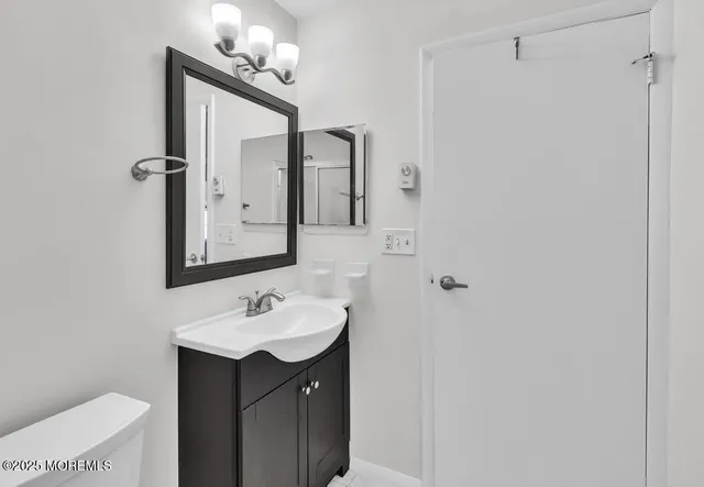 a white bath tub sitting next to a white toilet and a shower