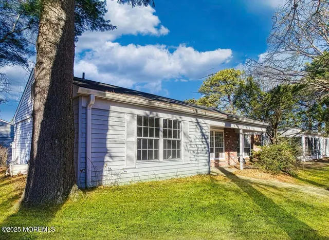 a view of house with a backyard space