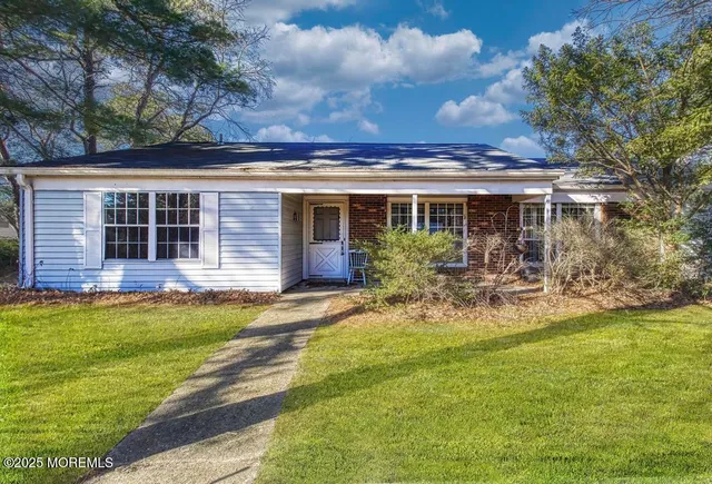 a house view with swimming pool and garden space