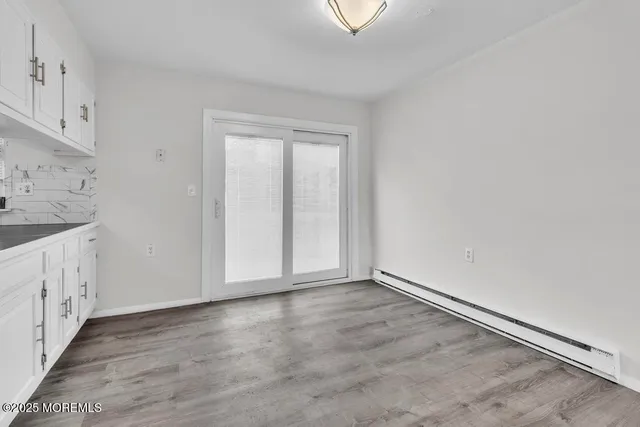 a view of cabinets a wooden floor and a window