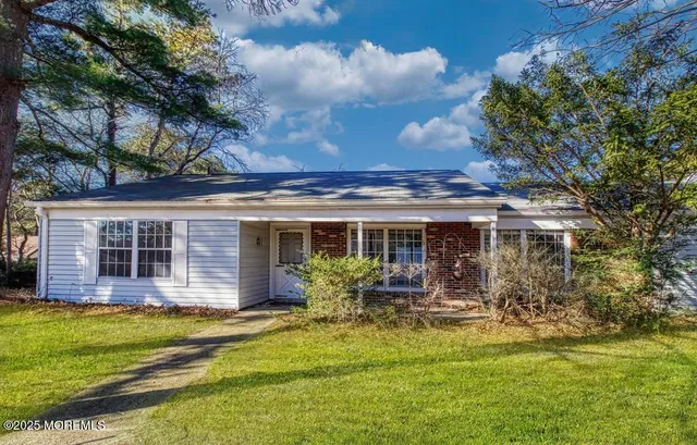 a view of a house with a large window and wooden fence