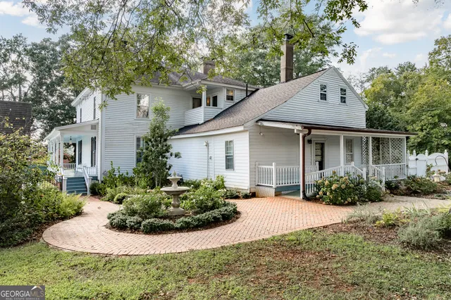 an aerial view of a house with a big yard and large trees