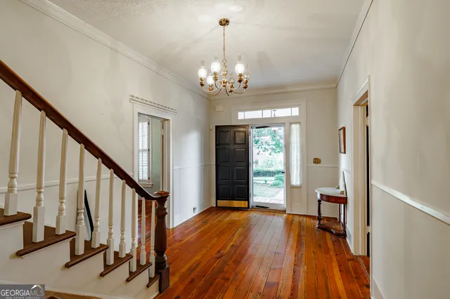 a living room with furniture a chandelier and a window