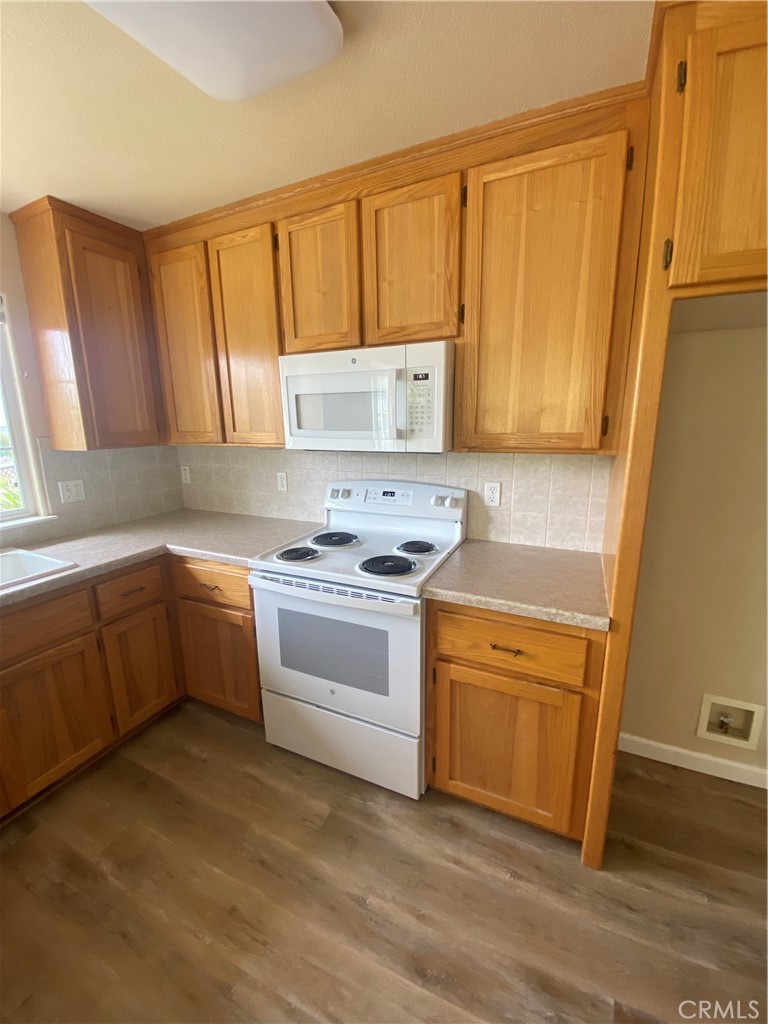 16506 Ridgecrest Court Hidden Valley Lake, CA 95467 - Photo 5 of 25 a kitchen with a white stove top oven sink and cabinets