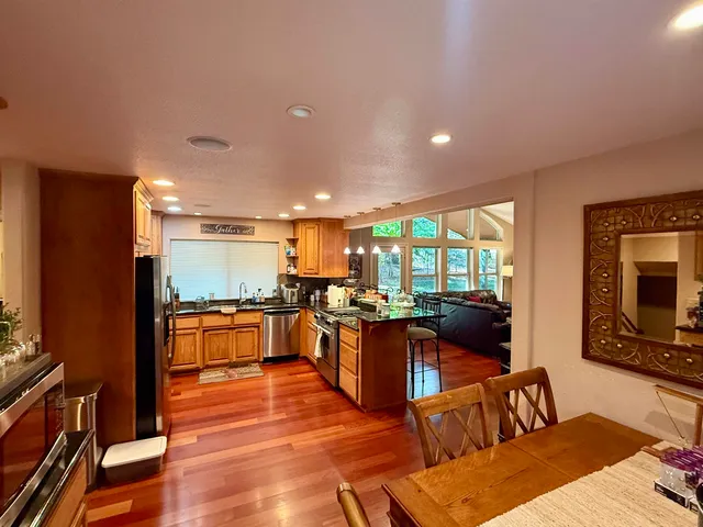 a living room with furniture a flat screen tv and wooden floor