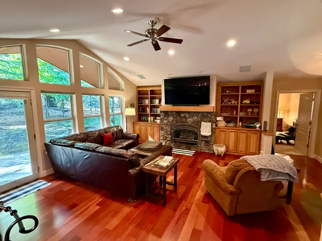 a living room with furniture fireplace and a flat screen tv