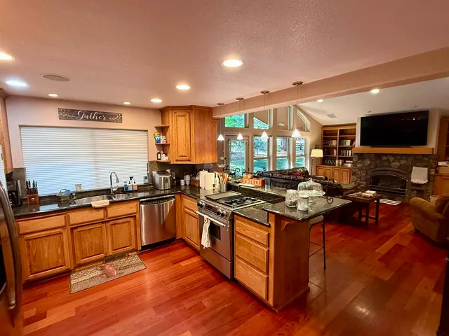 a kitchen with stainless steel appliances granite countertop a stove and a sink