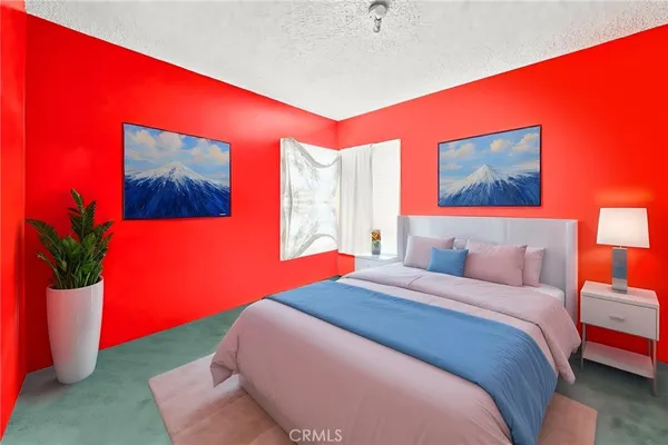a bedroom with a bed potted plant and a window